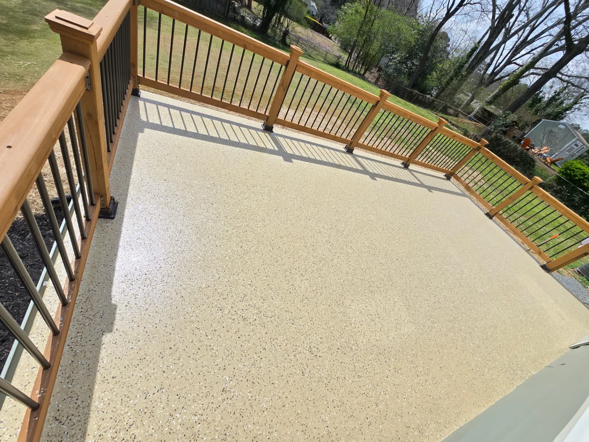 Durable flake epoxy floor with a cedar railing installed.