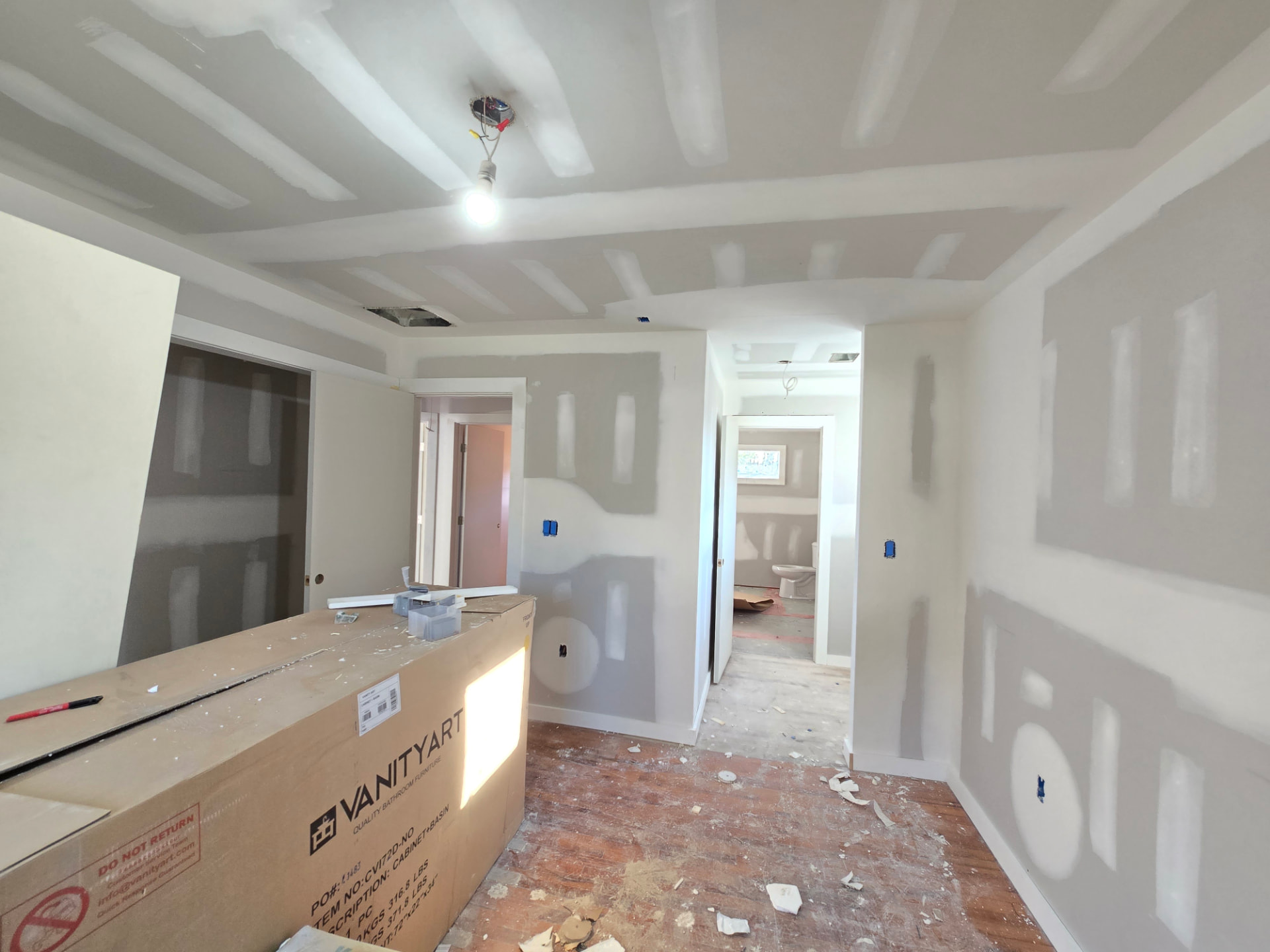 Hung and taped sheetrock with smooth-sanded seams, ready for paint.