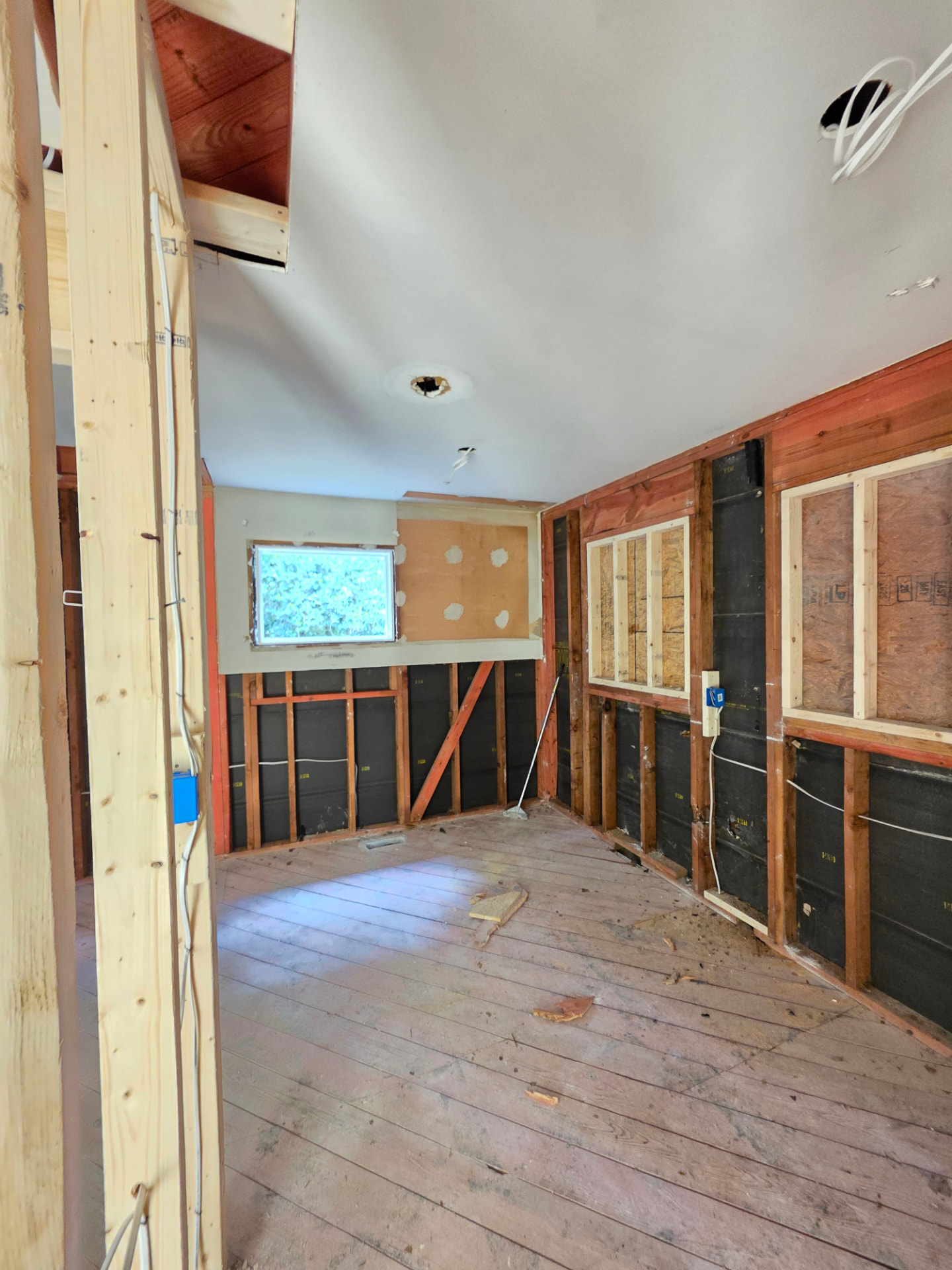 New framing and window openings prepped for sheetrock.